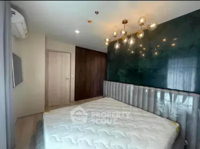 Modern bedroom with stylish lighting and elegant headboard in a contemporary apartment.