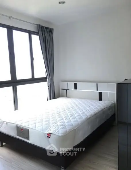 Bright bedroom with large window and modern furnishings