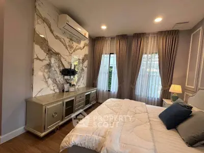 Luxurious bedroom with elegant marble accent wall and stylish decor