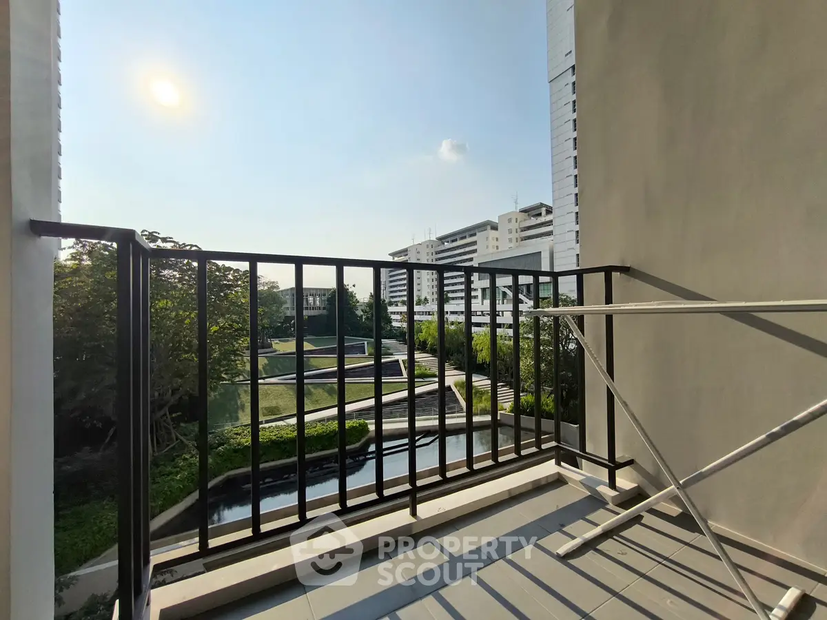 Modern balcony with scenic view of urban landscape and lush greenery, perfect for relaxation.