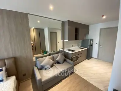 Modern studio apartment with sleek kitchen and cozy living area