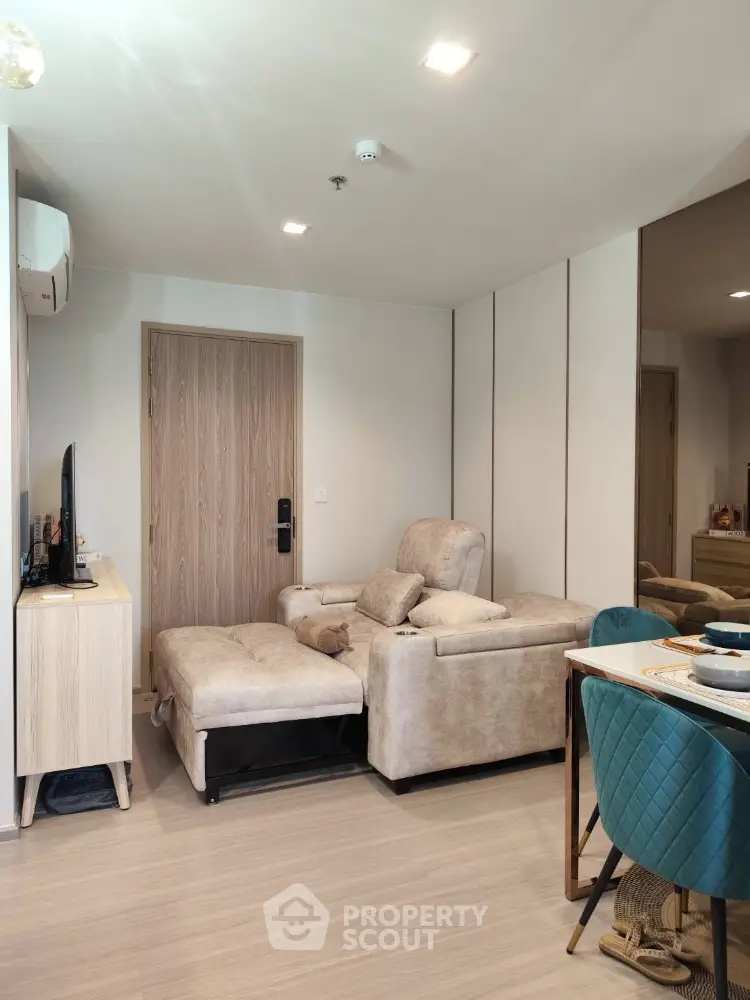 Modern living room with stylish furniture and dining area in open layout apartment.