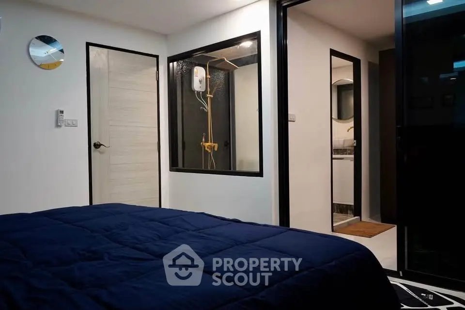 Modern bedroom with ensuite bathroom featuring sleek design and contemporary furnishings.
