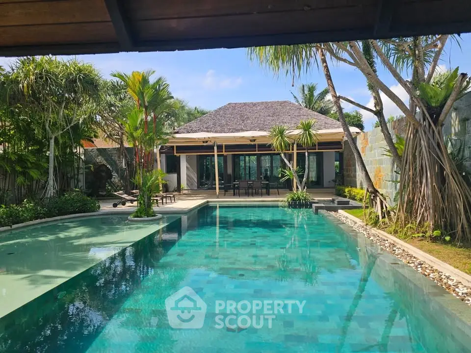 Luxurious villa with stunning pool and lush garden, perfect for tropical living.