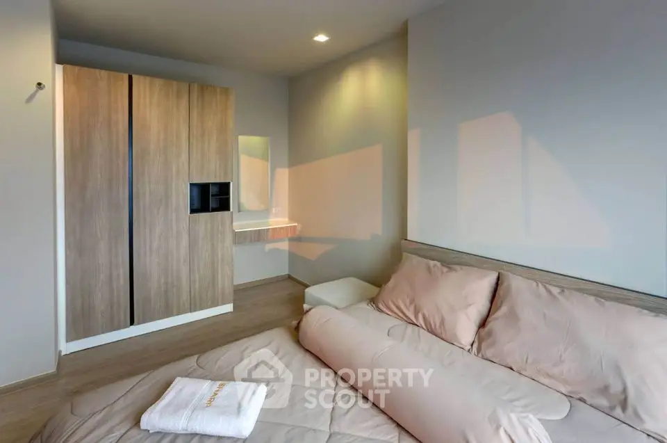 Modern bedroom with cozy bedding and sleek wardrobe design