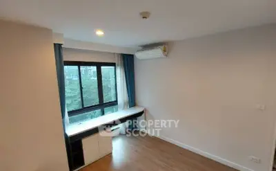 Modern study room with large window and air conditioning, featuring a sleek desk and storage cabinets.