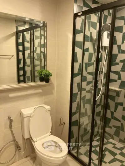 Modern bathroom with geometric tile shower and sleek fixtures