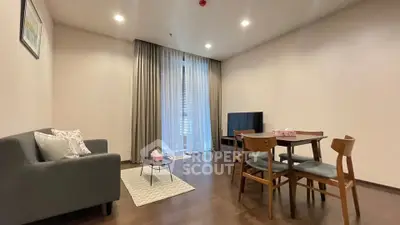 Spacious living room with modern furniture and large window in a stylish apartment.