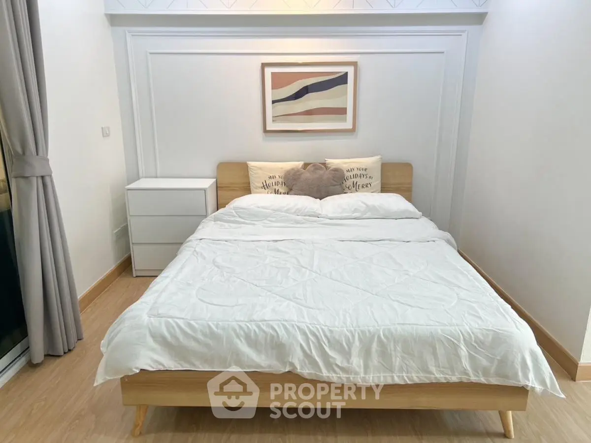 Cozy modern bedroom with stylish decor and wooden flooring
