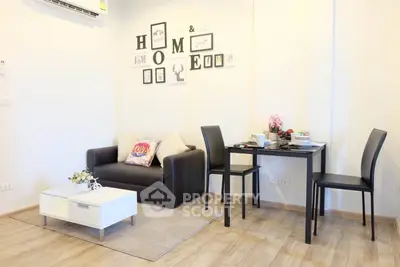 Modern living room with stylish decor and dining area in a cozy apartment.