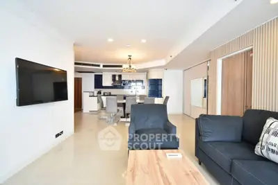 Spacious modern living room with open kitchen and elegant furnishings