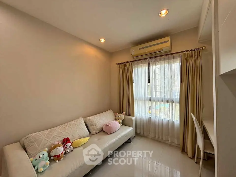 Cozy living room with plush sofa and natural light from large window