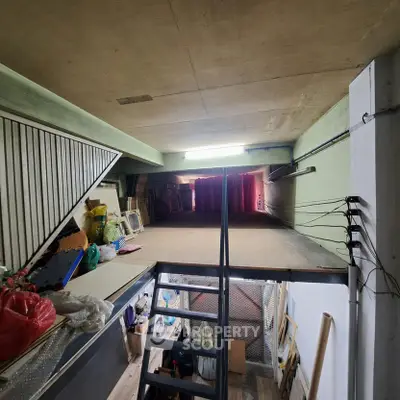Spacious storage area with mezzanine and ladder access, ideal for versatile use in urban settings.