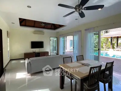 Spacious living room with pool view and modern decor