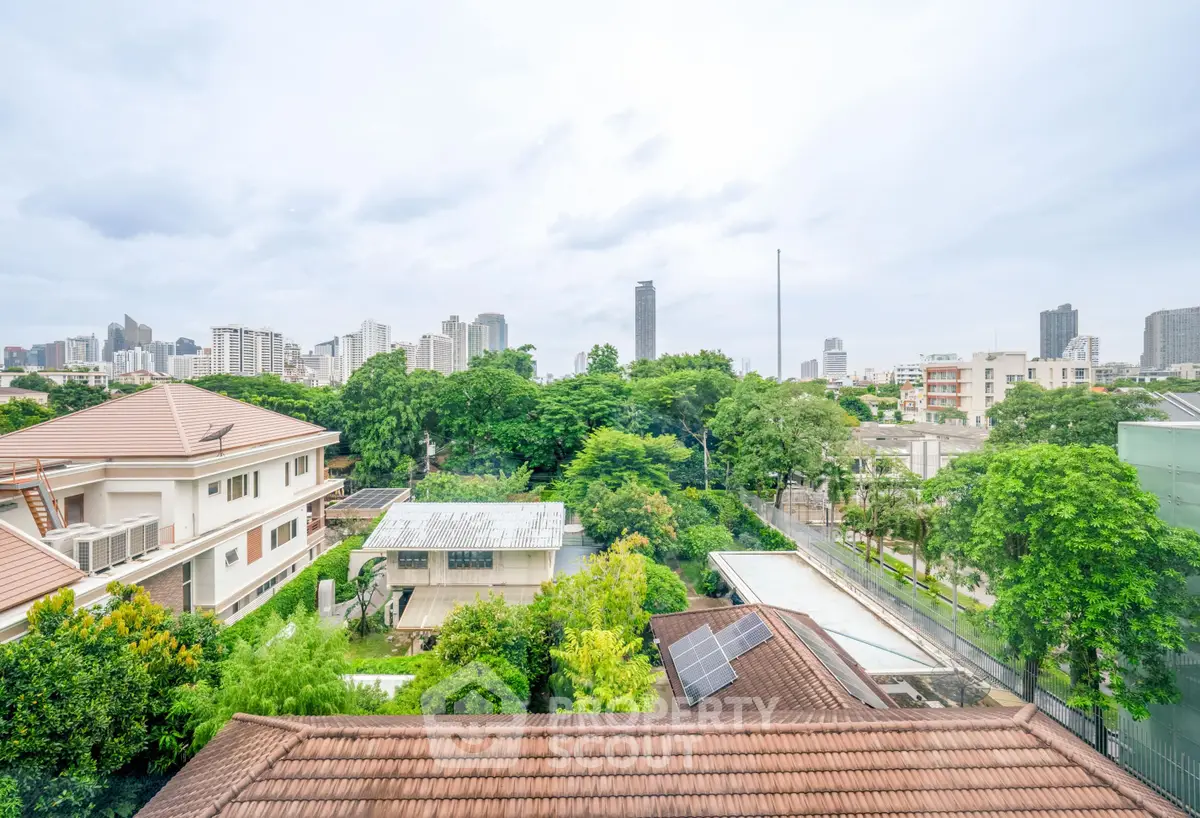Stunning cityscape view from a rooftop showcasing lush greenery and urban skyline.