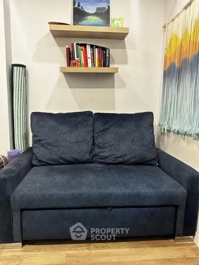 Cozy living room with plush sofa and stylish decor, perfect for relaxation.