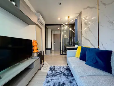 Modern living room with stylish decor and plush seating in a contemporary apartment.