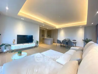 Spacious modern living room with open kitchen and elegant lighting