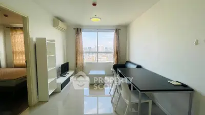 Modern living room with city view, sleek furniture, and natural light in a high-rise apartment.