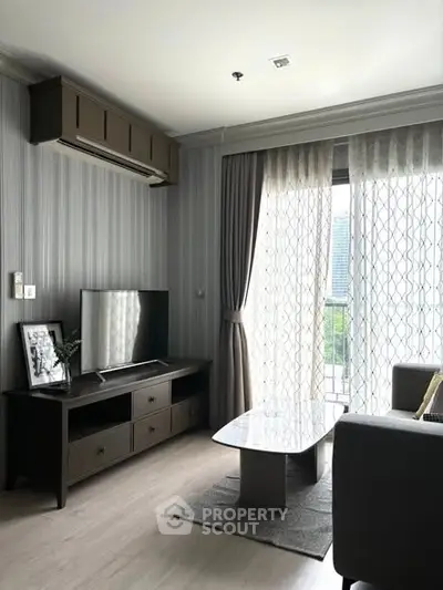 Modern living room with stylish decor and natural light from large windows.