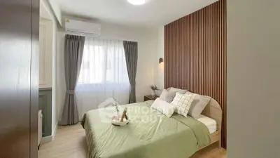 Modern bedroom with stylish wood paneling and cozy decor