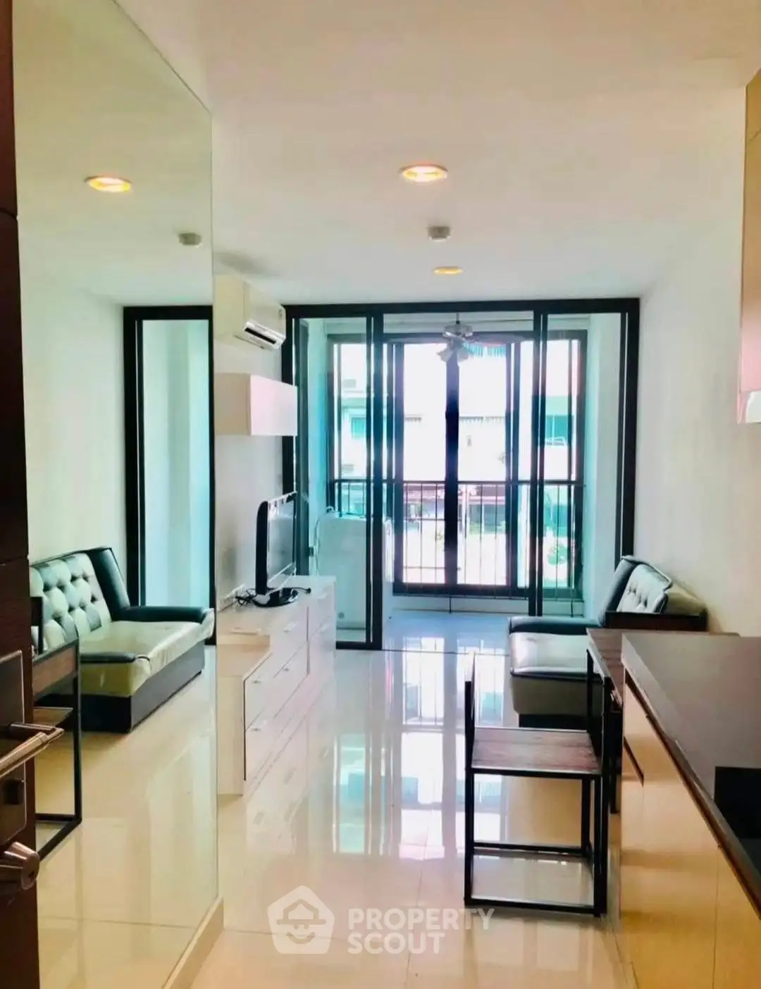 Modern living room with sleek furniture and large windows in a stylish apartment.