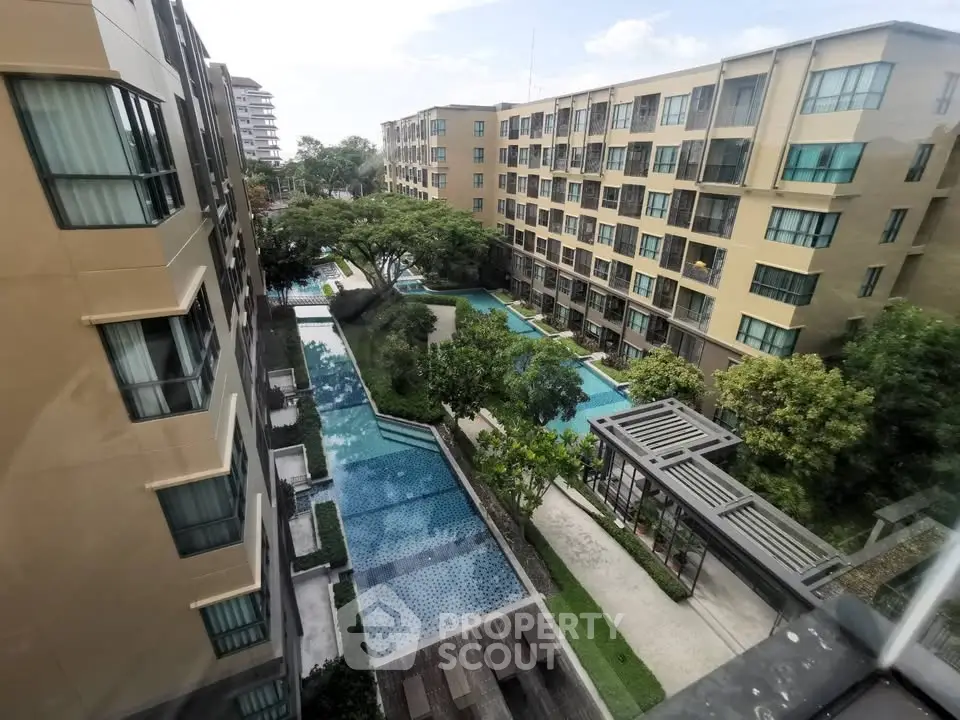 Modern apartment complex with pool and landscaped garden view