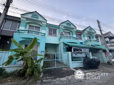 Charming turquoise townhouse with balcony and garden in a serene neighborhood