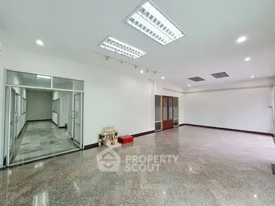 Spacious office space with modern lighting and marble flooring