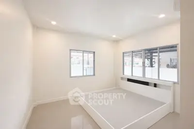 Minimalist bedroom with large windows and elevated platform