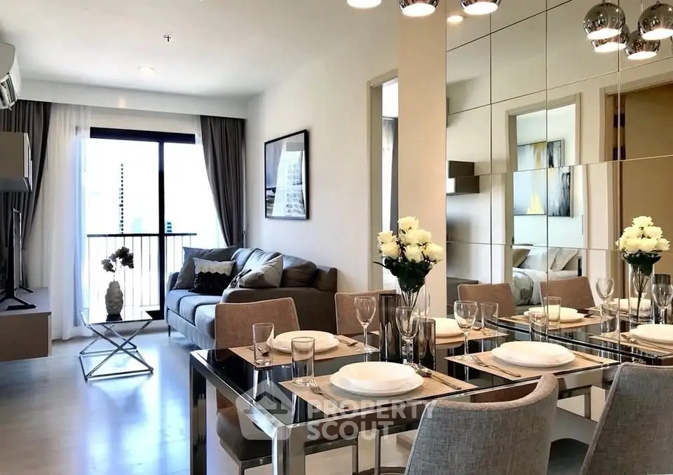Stylish modern living room with dining area, elegant decor, and large windows for natural light.