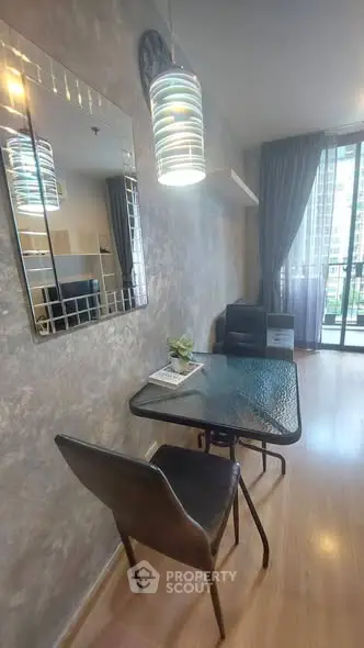 Modern living room with stylish decor and balcony view in a contemporary apartment.