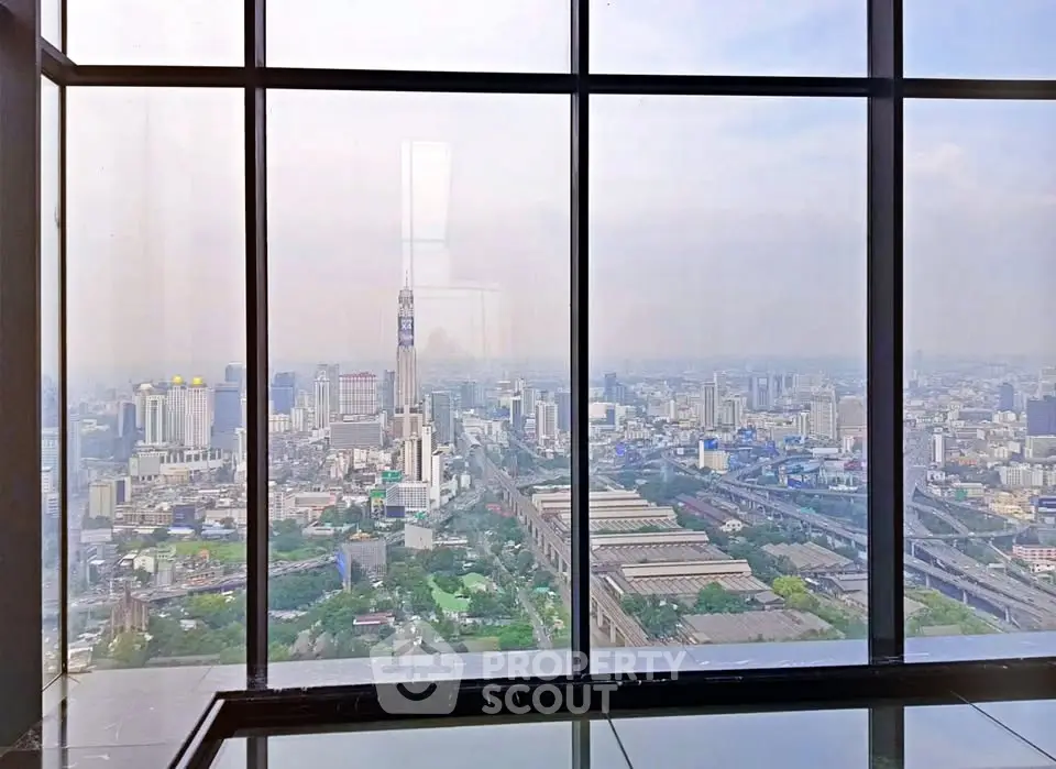 Stunning cityscape view from high-rise building window, showcasing urban skyline and architectural marvels.