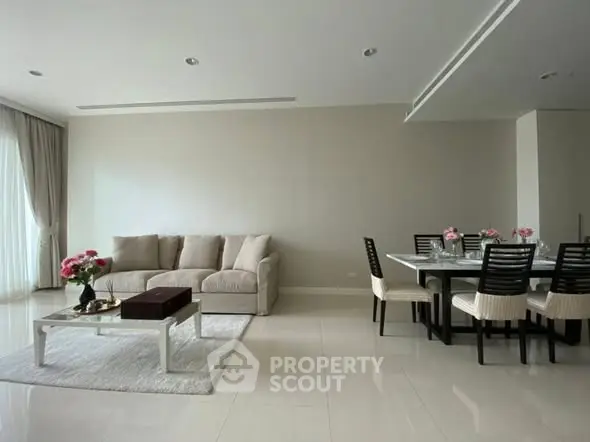 Spacious modern living room with elegant dining area and plush sofa