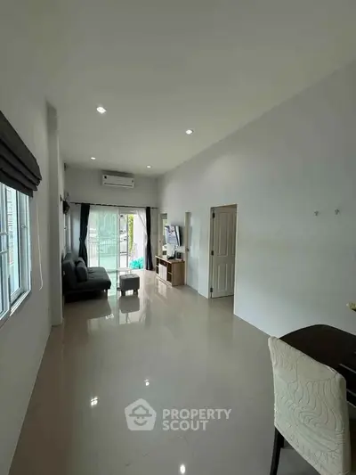Spacious modern living room with sleek design and abundant natural light.