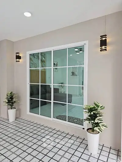 Modern interior with large window and stylish lighting in a contemporary living space.