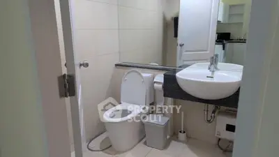 Modern bathroom with sleek fixtures and neutral tiles in a contemporary home.