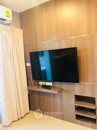 Modern living room with wall-mounted TV and elegant wood paneling