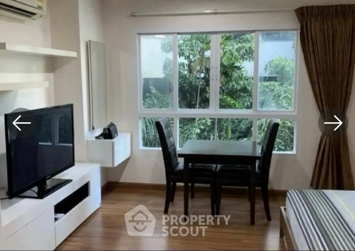 Cozy living room with dining area and large window view