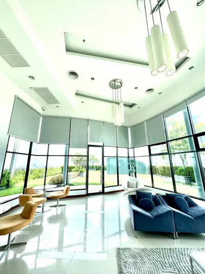 Luxurious modern living room with floor-to-ceiling windows and elegant furniture.
