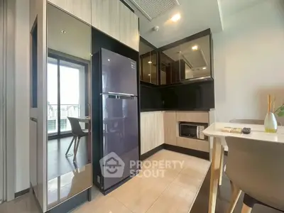 Modern kitchen with sleek appliances and open layout, featuring a stylish dining area and city view.
