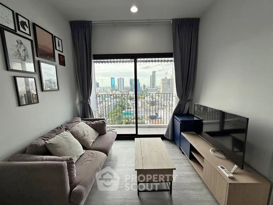 Modern living room with city view, stylish decor, and cozy seating area in urban apartment.