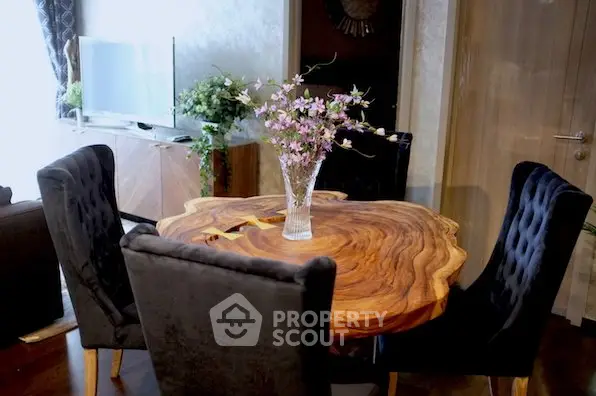 Elegant dining area with unique wooden table and plush chairs