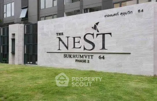 Modern building entrance with stylish signage at The Nest Sukhumvit 64 Phase 2.