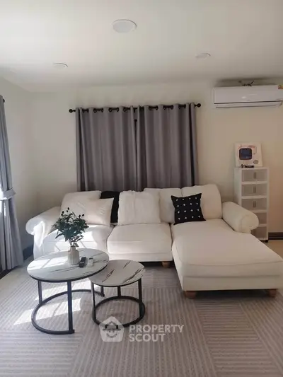 Stylish living room with modern white sectional sofa and chic decor