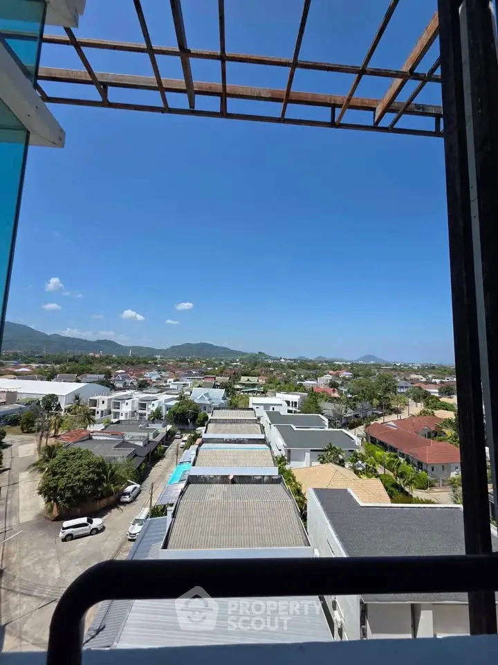 Stunning panoramic view from a high-rise balcony overlooking a serene residential neighborhood.