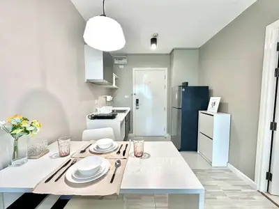 Modern kitchen with dining area, featuring sleek appliances and stylish decor, perfect for contemporary living.