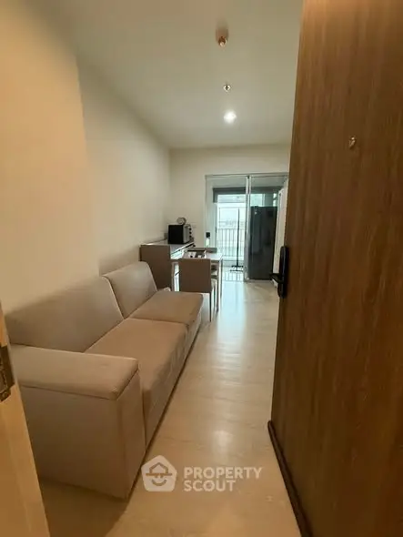 Modern living room with cozy sofa and balcony view in a stylish apartment.