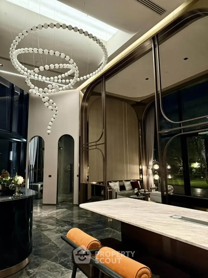 Luxurious modern living room with high ceilings and elegant chandelier