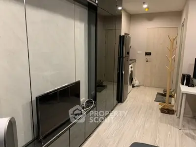 Modern apartment interior with sleek design, featuring a washing machine and stylish decor.